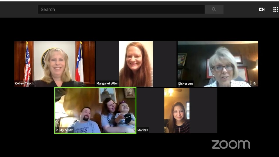Am image of a judge, an attorney, and families communicating on zoom