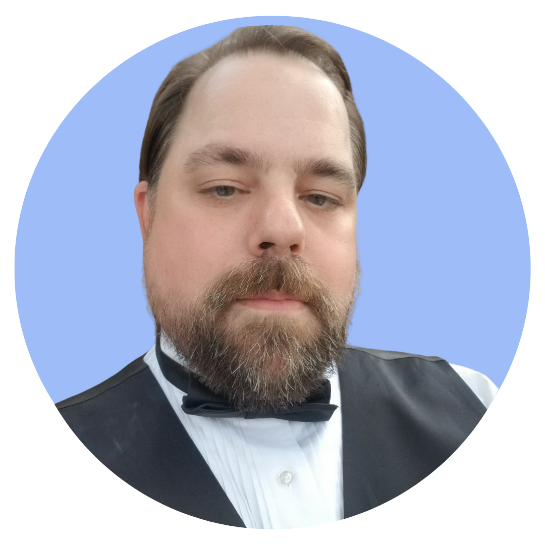 Headshot of Nick Rogers with a light blue background.